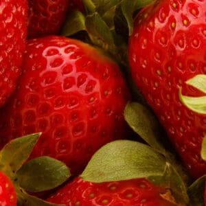 A close up of some strawberries with leaves