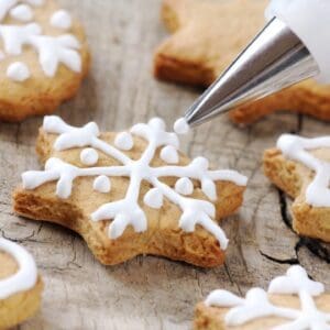 A cookie cutter is being used to decorate some cookies.