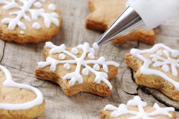 A cookie cutter is being used to decorate some cookies.