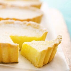 A close up of some lemon tarts on a plate