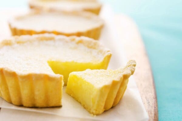 A close up of some lemon tarts on a plate